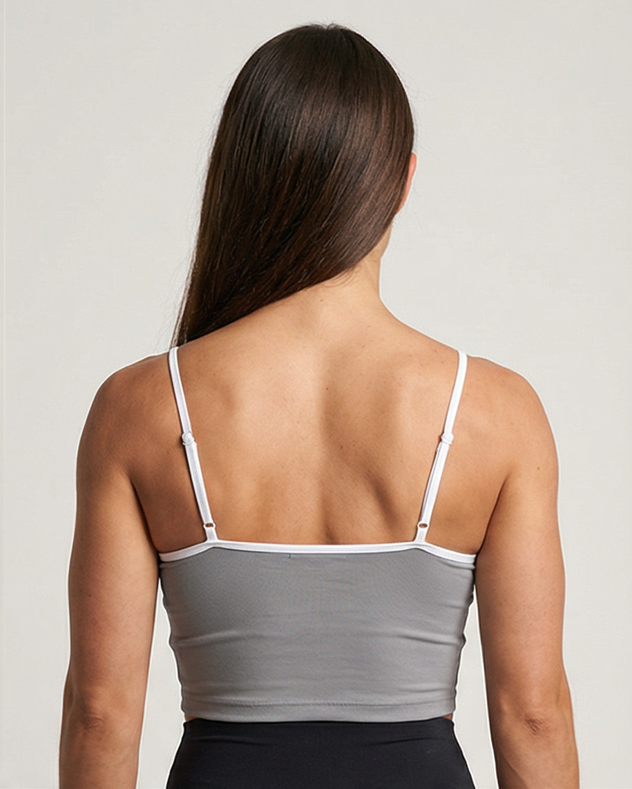 Schwarzes Golden Vein Essential Crop Top aus weichem Stretchmaterial, getragen von einem sportlichen weiblichen Model in Studioaufnahme; klare Silhouette und minimalistisches Design. Rücken Ansicht.